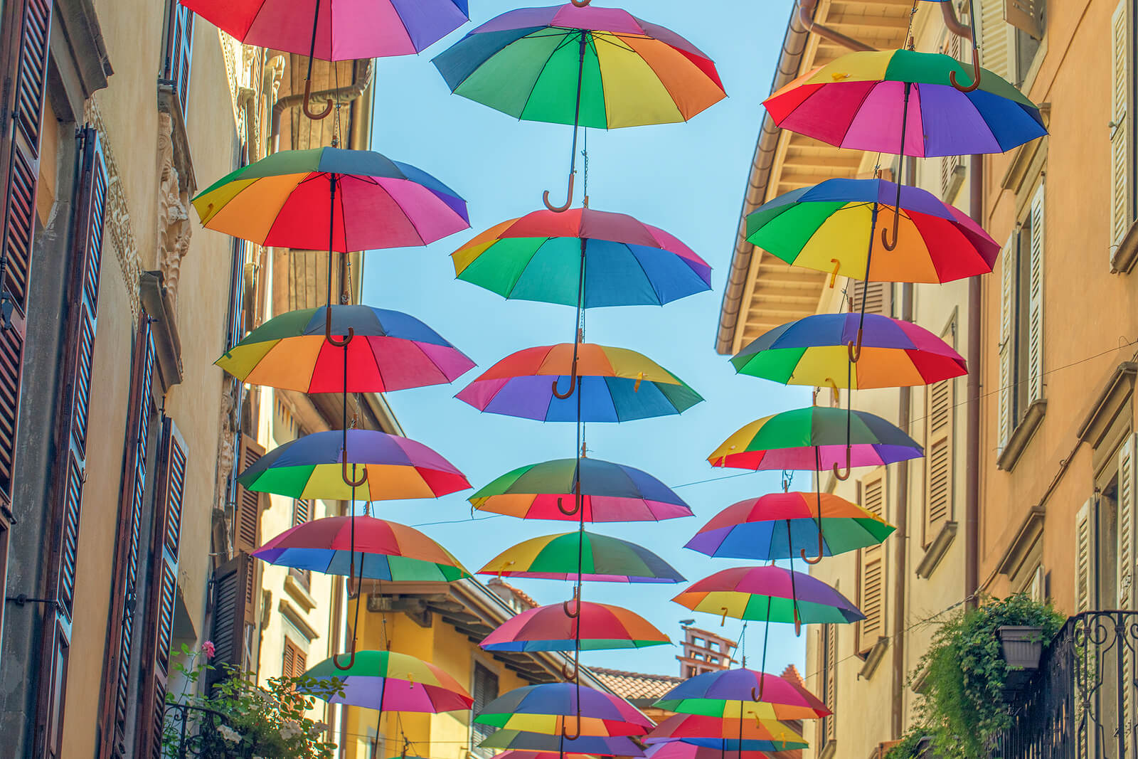 Several rainbow umbrellas float in the air. There are neurodivergent-affirming therapists in San Francisco, Berkeley & Campbell, CA.