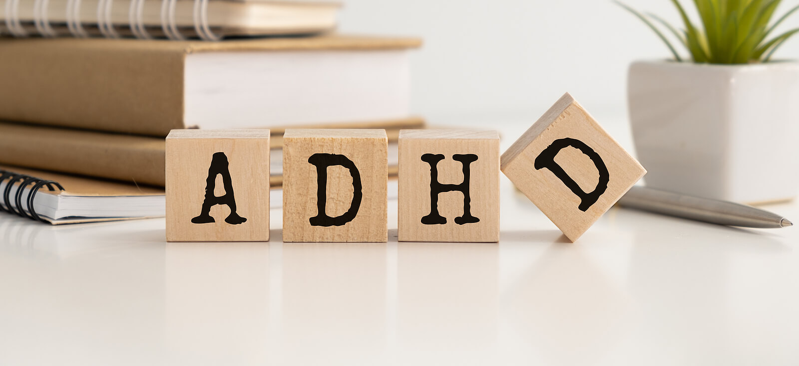 ADHD is spelled on wooden blocks. Curious about ADHD testing in San Francisco, CA area? Learn more here from our neurodiversity-affirming psychologists here!