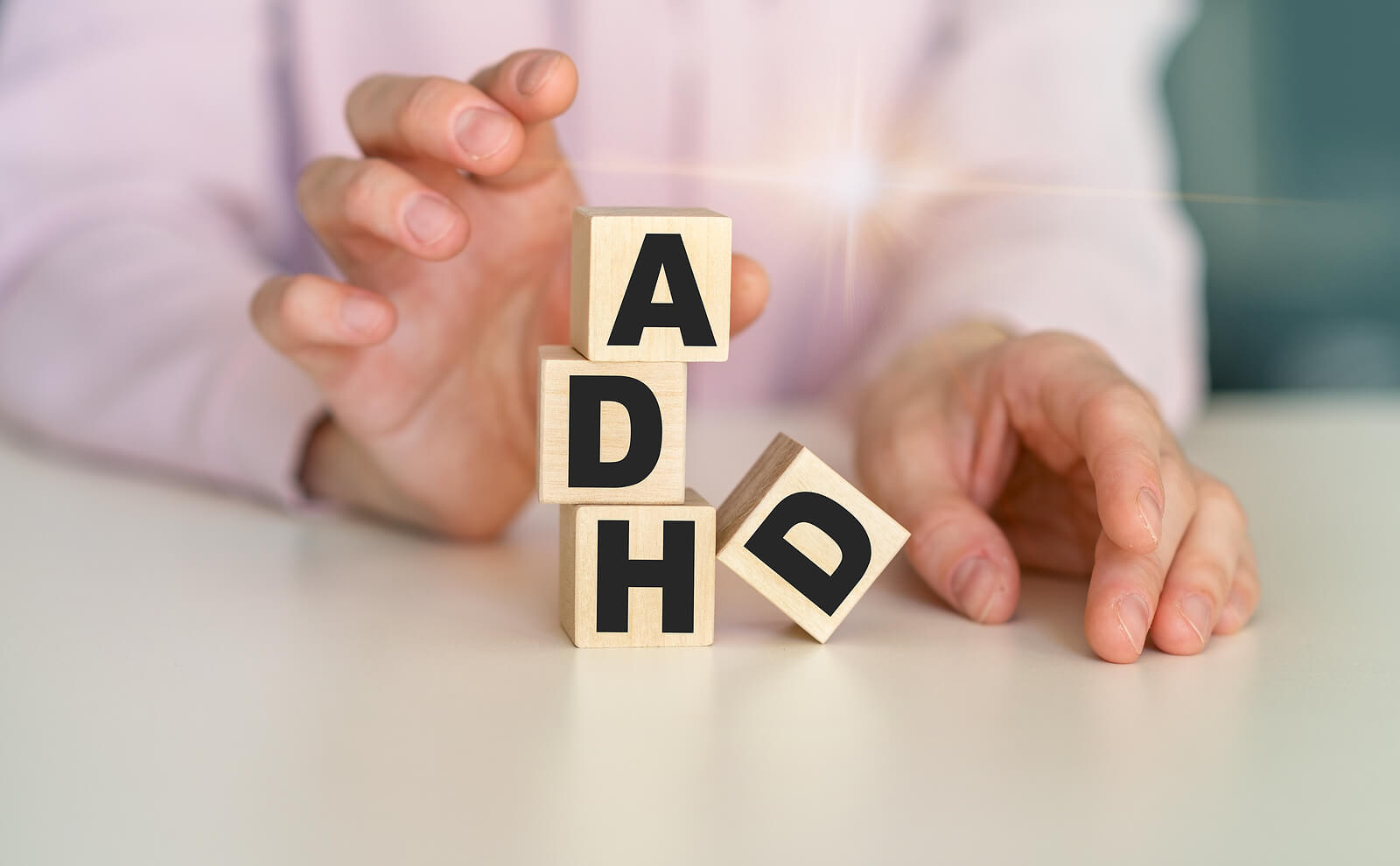 ADHD is spelled on wooden blocks. Wondering about ADHD testing in San Francisco, CA area? Learn more here from our ADHD affirming psychologists here!