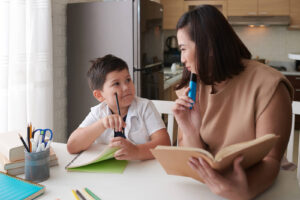A mom & son working together on school work. Learning disability testing in San Francisco, CA can benefit your child with dyslexia or dyscalculia. Learn more here!