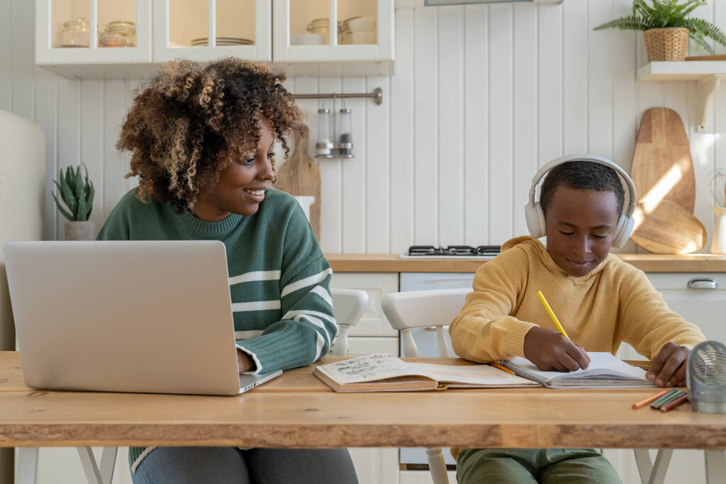 A mother smiling at her son who is listening to music and doing school work. If you're a parent who wants to educate themselves about ADHD testing in San Francisco, CA then you're at the right place. Learn more about ADHD testing in Berkeley, CA here!