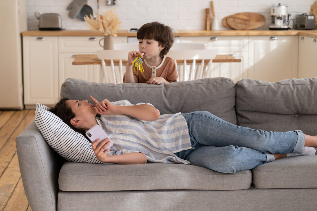 A child blowing into a party toy and alerting mother on the couch. Are you looking for ADHD testing in the San Francisco or Berkeley, CA area? Learn how to better support your child here with ADHD testing.