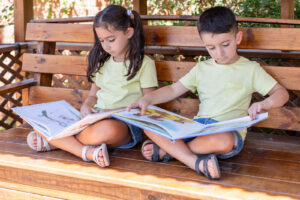 A young boy sitting on a bench with a young girl both reading story books. Dyslexia evaluations in Berkeley & San Francisco, CA are here for you & your child. Learn more about dyslexia here. 