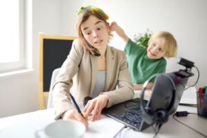 A mother talking on the phone while working hard, while her child pulls on her ear. Did you know we offer ADHD testing in 2 different locations? Learn more about ADHD testing in Berkeley & San Francisco, CA here!