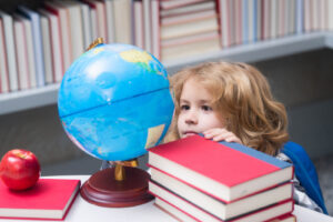 A young child observing the world globe by school books. If you're looking for neurodevelopmental screenings in Berkeley, CA, or San Francisco, CA then our psychologists can help you. Contact us today to learn more about psychoeducational evaluations.